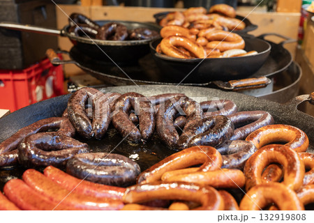 vendor fries meat and sausage on the grill in the city center at the Christmas market in Gdansk Poland 132919808