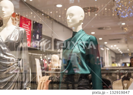 mannequins on display in a store with clothes in a shopping center 132919847