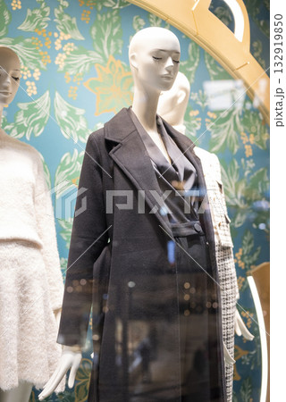 mannequins on display in a store with clothes in a shopping center 132919850