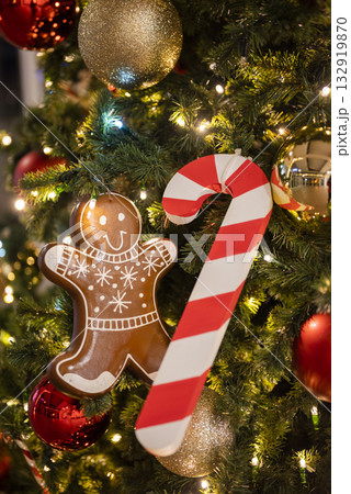 christmas tree for christmas with garland and decorations and candy cane santa claus with gingerbread man 132919870