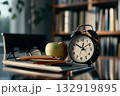Old alarm clock, glasses, colored pencils and books on wooden table. Blurred background with bookshelves. Concept of advertising materials, education, reading, learning, time management. Copy space 132919895