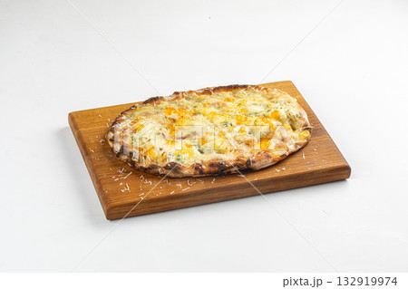 Isolated four cheese pizza on wooden board 132919974