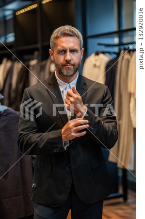 Businessman choose elegant suit in store. Trendy suit jacket. Hispanic businessman choosing tailoring. Bespoke tailoring. Male model in suit boutique. Stylish man in suit. Business attire 132920016
