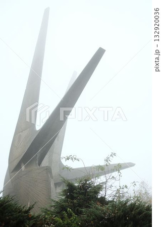 The concrete spires of the Kosmaj Monument emerge through dense morning fog, symbolizing strength and remembrance amid silence The concrete spires of the Kosmaj Monument emerge through dense morning fog, symbolizing strength and remembrance amid silence 132920036
