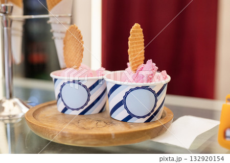 Delicious fruit ice cream in a takeaway cup on display at a cafe 132920154