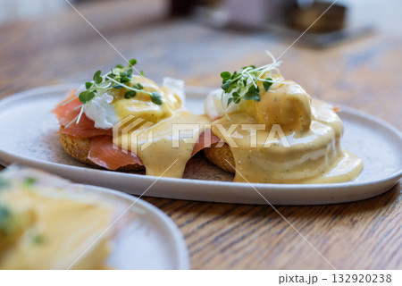 breakfast bruschetta toast with cheese sauce with egg and salmon in a restaurant breakfast bruschetta toast with cheese sauce with egg and salmon in a restaurant 132920238