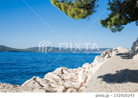 a beautiful beach with a view of the Adriatic Sea with rocks on the shore and pine trees in Zadar, Croatia a beautiful beach with a view of the Adriatic Sea with rocks on the shore and pine trees in Zadar, Croatia 132920243
