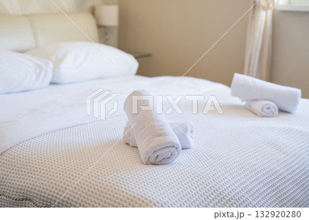 neatly folded towels on the beds in the hotel room service and hotel cleaning 132920280