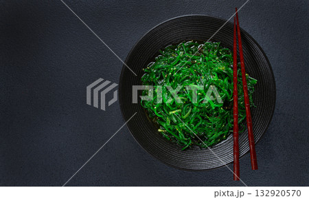 Chuka salad, made from fresh seaweed, with sesame dressing, served in a black bowl, with chopsticks, Chuka salad, made from fresh seaweed, with sesame dressing, served in a black bowl, with chopsticks, 132920570