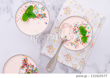 fruit mousse, made from jelly and cottage cheese, in glasses, decorated with sprinkles and mint, homemade 132920577