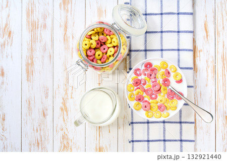 Healthy breakfast, bowl of colorful corn rings with milk . Top view. 132921440