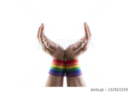 Open hands with colorful rainbow LGBT wristband isolated on white background with clipping path. Holding, giving, showing concept. Open hands with colorful rainbow LGBT wristband isolated on white background with clipping path. Holding, giving, showing concept. 132921539