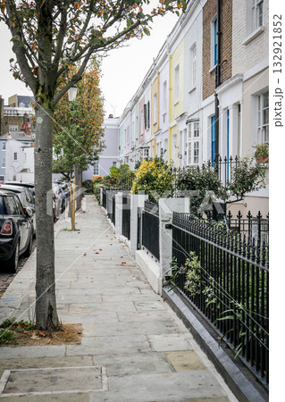 Colorful Residential Street with Iron Fence and Trees 132921852