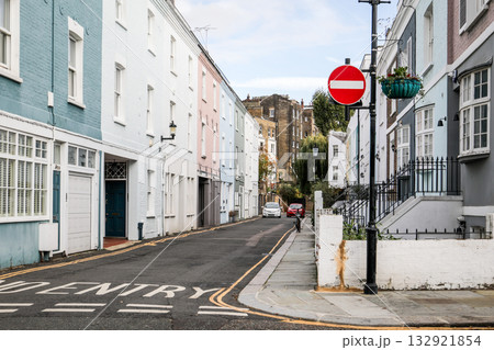 Quiet urban street with pastel-colored houses and a red no entry traffic sign. Architecture, city Quiet urban street with pastel-colored houses and a red no entry traffic sign. Architecture, city 132921854