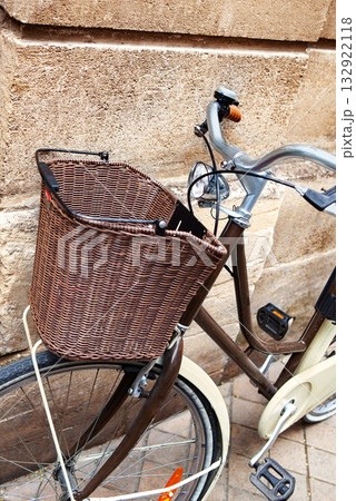 Parking an urban bicycle against a stone wall 132922118