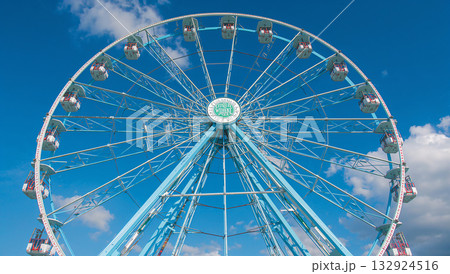 Colorful Ferris Wheel Against Blue Sky in Amusement Park Colorful Ferris Wheel Against Blue Sky in Amusement Park 132924516