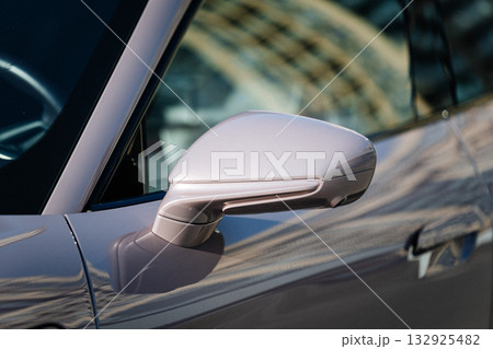 Vinnitsya Ukraine-15 July 2025:Pink Porsche Taycan side mirror close up with reflections of building Vinnitsya Ukraine-15 July 2025:Pink Porsche Taycan side mirror close up with reflections of building 132925482