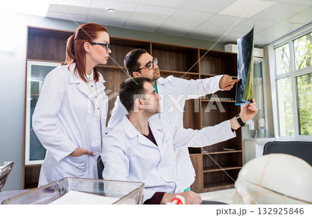 Doctors team having medical council in hospital. Discussing medical issues. Doctors team having medical council in hospital. Discussing medical issues. 132925846
