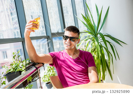 Young man in the pub. Drinking beer, eating pizza. Young man in the pub. Drinking beer, eating pizza. 132925890