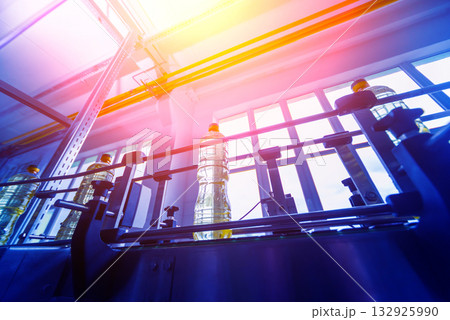 Bottling line of sunflower oil in bottles. Vegetable oil production plant 132925990