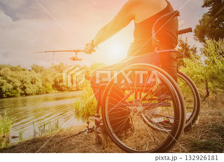Handicapped man fishing at a lake. Wheelchair camping. 132926181