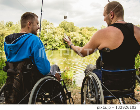 Handicapped men fishing at a lake. Wheelchair. Camping. 132926182