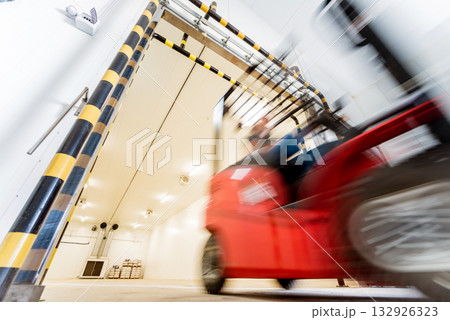 Forklift in a large industrial freezer warehouse. Forklift in a large industrial freezer warehouse. 132926323
