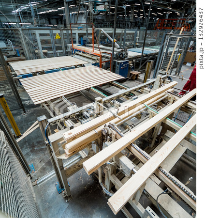 Production line of the wooden floor factory. CNC automatic woodworking machine. 132926437