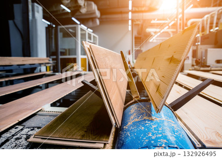 Production line of the wooden floor factory. CNC automatic woodworking machine. 132926495