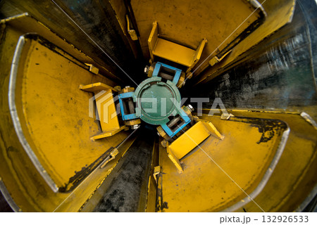 Rolled steel coils in storage areas of metalwork manufacturing. 132926533