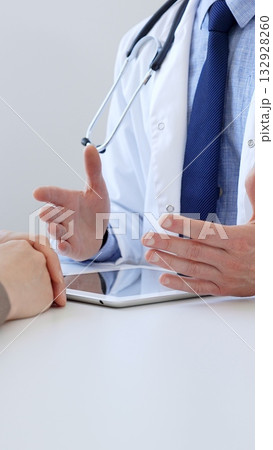 Doctor gesturing with hands while explaining diagnosis to patient during medical consultation in hospital office, healthcare and medical concept. Medicine Doctor gesturing with hands while explaining diagnosis to patient during medical consultation in hospital office, healthcare and medical concept. Medicine 132928260