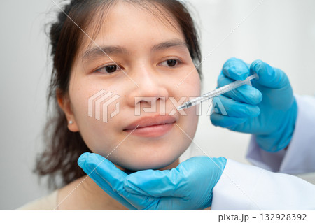 Asian woman receiving filler beauty injection. Asian woman receiving filler beauty injection. 132928392