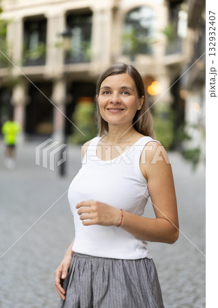 Female pedestrian in summer European capital, person in city 132932407
