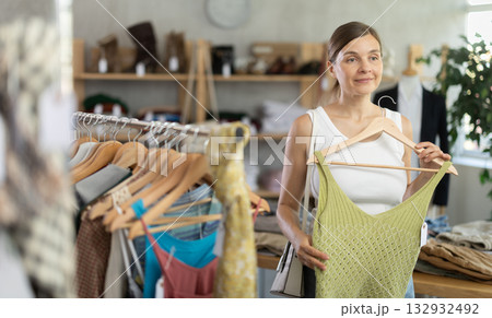 Adult woman choosing top in clothing store 132932492