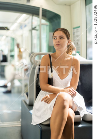 Young woman sitting quietly in bright modern tram 132932496