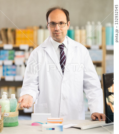 Adult male pharmacist invites to pharmacy 132932545