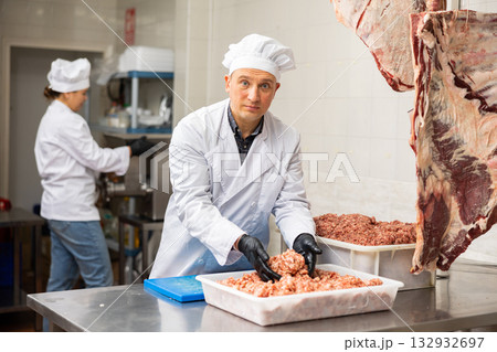 Adult man preparing minced meat in container Adult man preparing minced meat in container 132932697