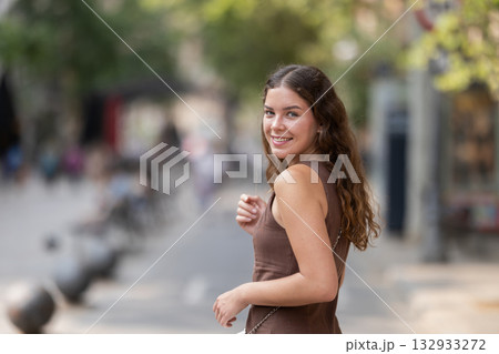 Young woman walking around summer european city 132933272