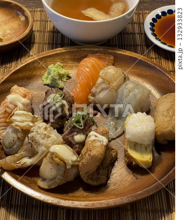 An assortment of fresh sushi, artfully arranged with a variety of toppings and vibrant colors. This traditional Japanese dish combines vinegared rice, seafood, and vegetables for an experience. 132933823
