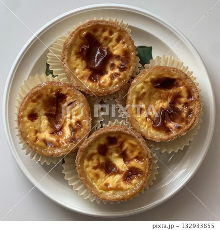 Golden egg tart with a flaky, buttery crust and a rich, creamy custard center. A deliciously satisfying treat for dessert or a light snack, blending texture and flavor perfectly. Golden egg tart with a flaky, buttery crust and a rich, creamy custard center. A deliciously satisfying treat for dessert or a light snack, blending texture and flavor perfectly. 132933855