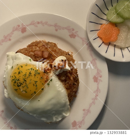 nasi goreng or fried rice traditional frying rice dish from indonesia made of Precooked rice fried in a small amount of oil, then spiced up with shallots, garlic, chili and sweet soy sauce. 132933881