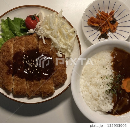 Crispy tonkatsu, a Japanese-style breaded and deep-fried pork cutlet, served with shredded cabbage and drizzled with savory sauce. A delightful balance of crunchy texture and juicy meat. Crispy tonkatsu, a Japanese-style breaded and deep-fried pork cutlet, served with shredded cabbage and drizzled with savory sauce. A delightful balance of crunchy texture and juicy meat. 132933903