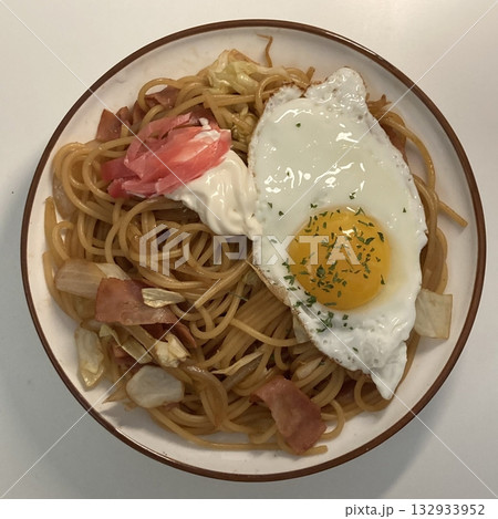A plate of spaghetti pasta, perfectly cooked and topped with rich marinara sauce and fresh herbs. Ideal for food photography and menus, capturing the heart of Italian cuisine in a delicious way. 132933952