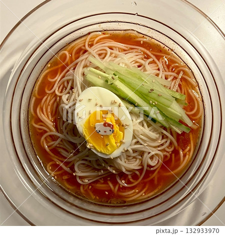 Chilled, chewy naengmyeon noodles in tangy broth paired with juicy, savory mandu dumplings, offering a perfect balance of refreshing coolness and hearty comfort in every delicious Korean bite. Chilled, chewy naengmyeon noodles in tangy broth paired with juicy, savory mandu dumplings, offering a perfect balance of refreshing coolness and hearty comfort in every delicious Korean bite. 132933970