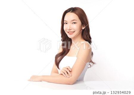 A beautiful young Asian woman with clean, fresh skin against a white background. Skincare, facial treatment, cosmetology, beauty, and spa. An elegant portrait of an Asian woman. 132934029