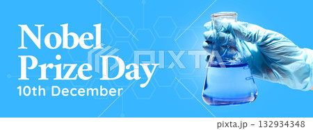 A hand in a glove holds a flask containing blue liquid 132934348