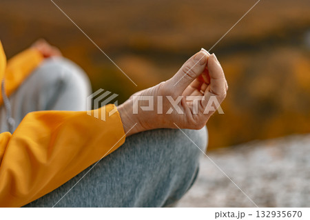 Hand meditation yoga mudra gesture during relaxation practice outdoors in autumn park. Hand meditation yoga mudra gesture during relaxation practice outdoors in autumn park. 132935670