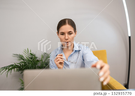 Businesswoman laptop concentration modern female entrepreneur considering data while working remotely 132935770