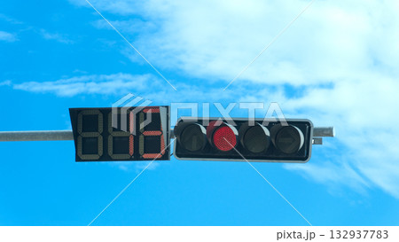 Traffic lights with bright red lights circle and number symbols. Background of blue sky and white clouds in the morning time. Traffic lights with bright red lights circle and number symbols. Background of blue sky and white clouds in the morning time. 132937783