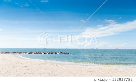 Clean beach area and clear blue sky and turquoise sea with coastal rock barrier. Time to travel with a bright atmosphere at Rayong Thailand. Clean beach area and clear blue sky and turquoise sea with coastal rock barrier. Time to travel with a bright atmosphere at Rayong Thailand. 132937785